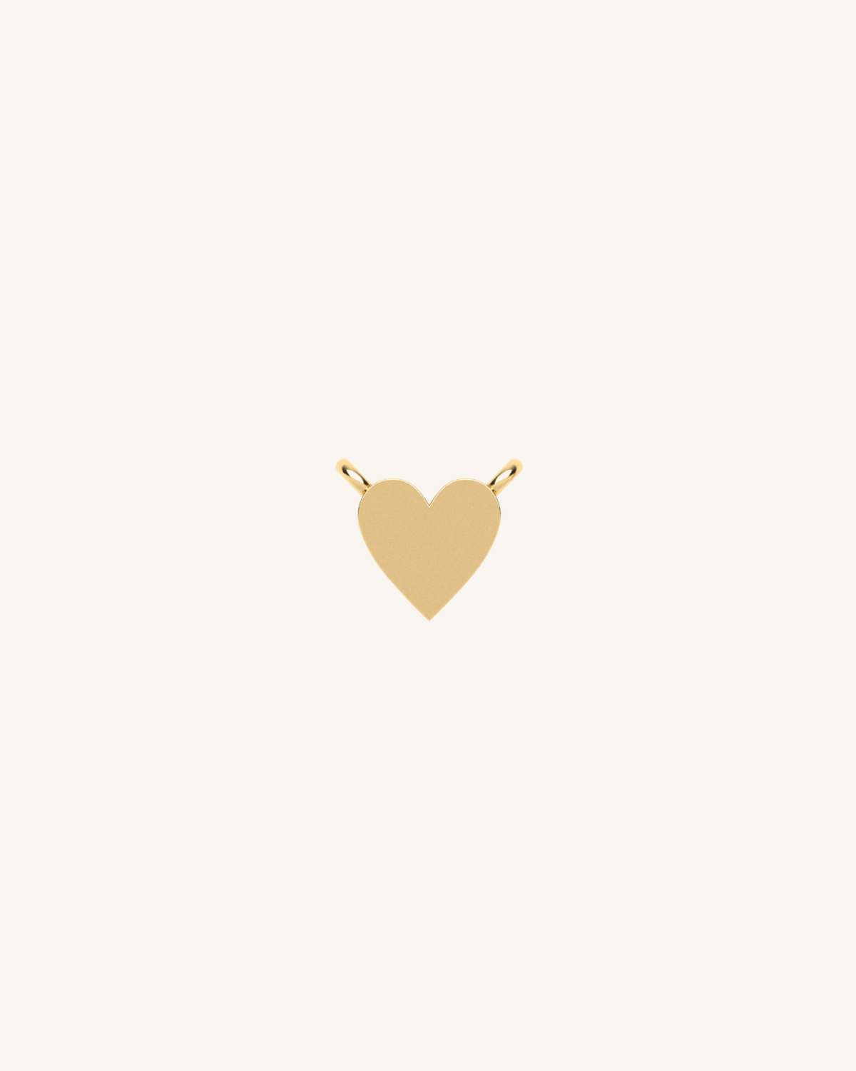 Gold heart charm with small loop top for attaching to jewelry