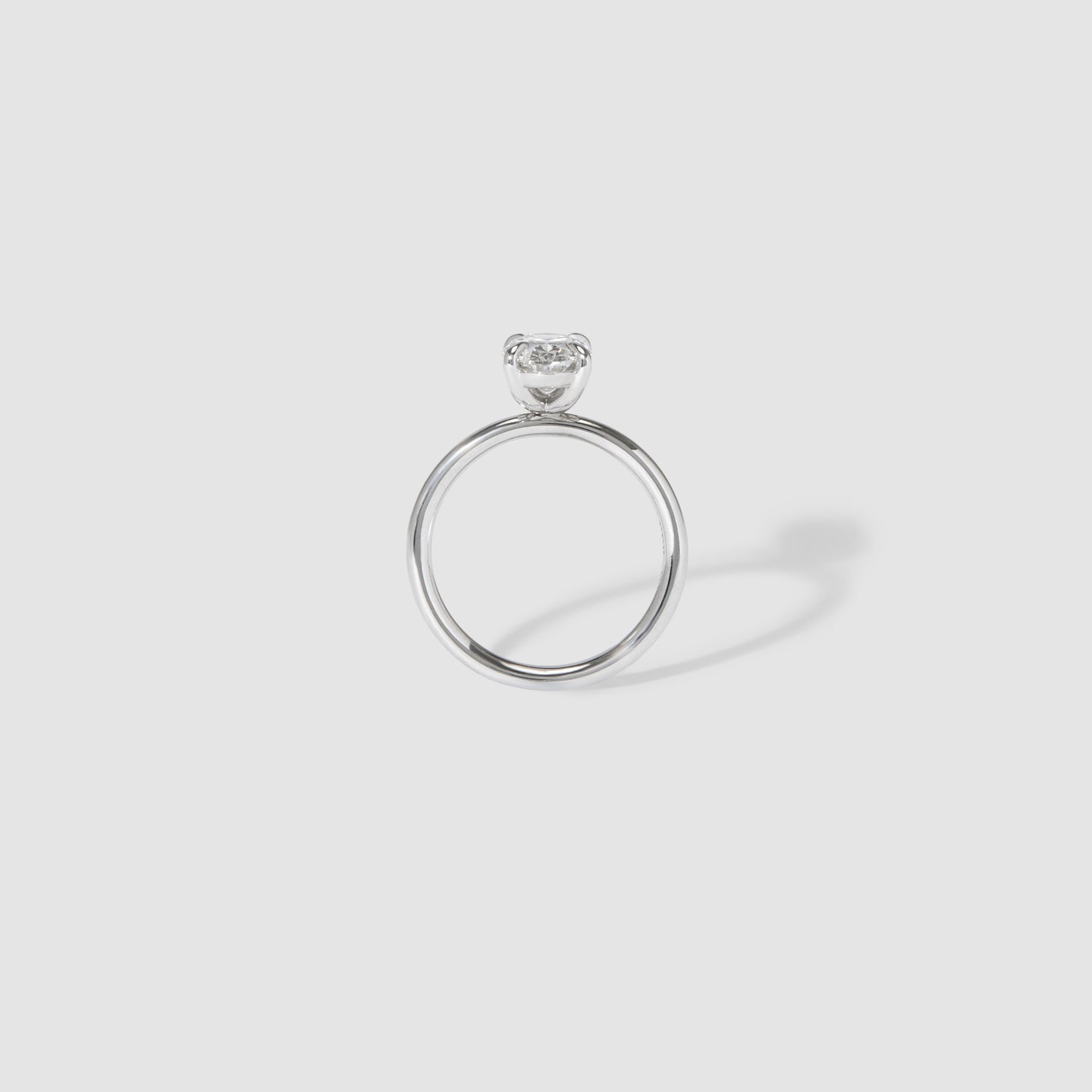 Elegant platinum ring featuring a solitaire diamond on a minimalistic band, set against a neutral background. Perfect for luxury jewellery lovers.