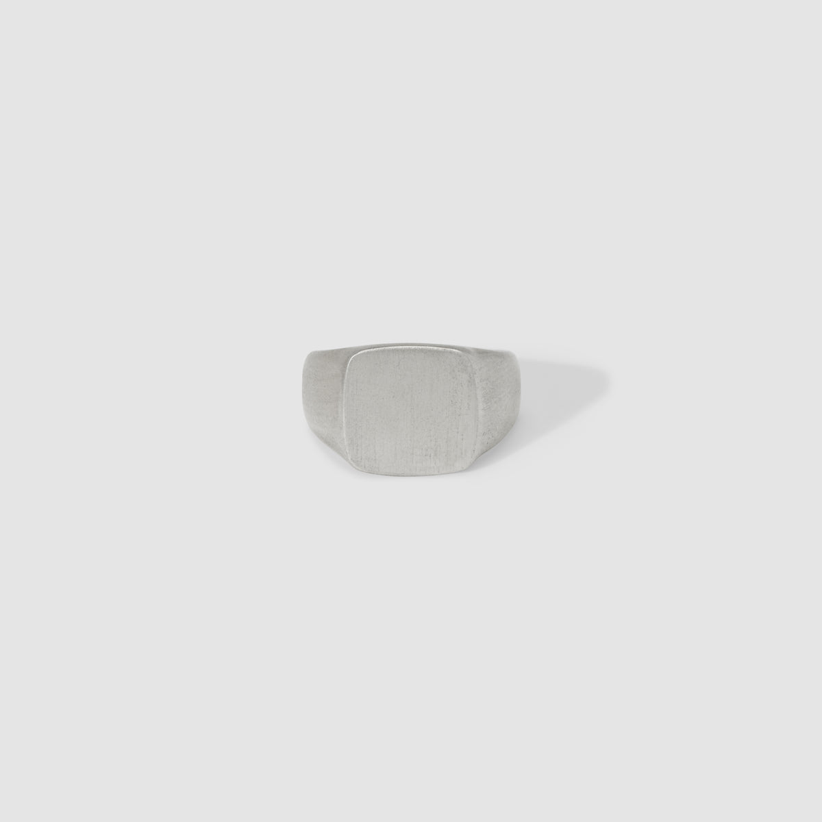 Luxurious light grey velvet jewellery ring box displayed on a minimalist white background, ideal for showcasing high-end rings.