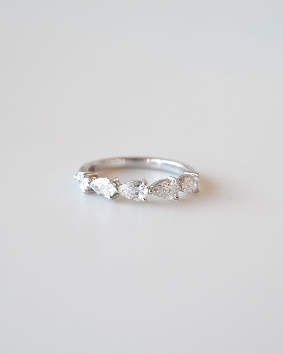 White gold diamond wedding ring with pear-shaped stones, slim band