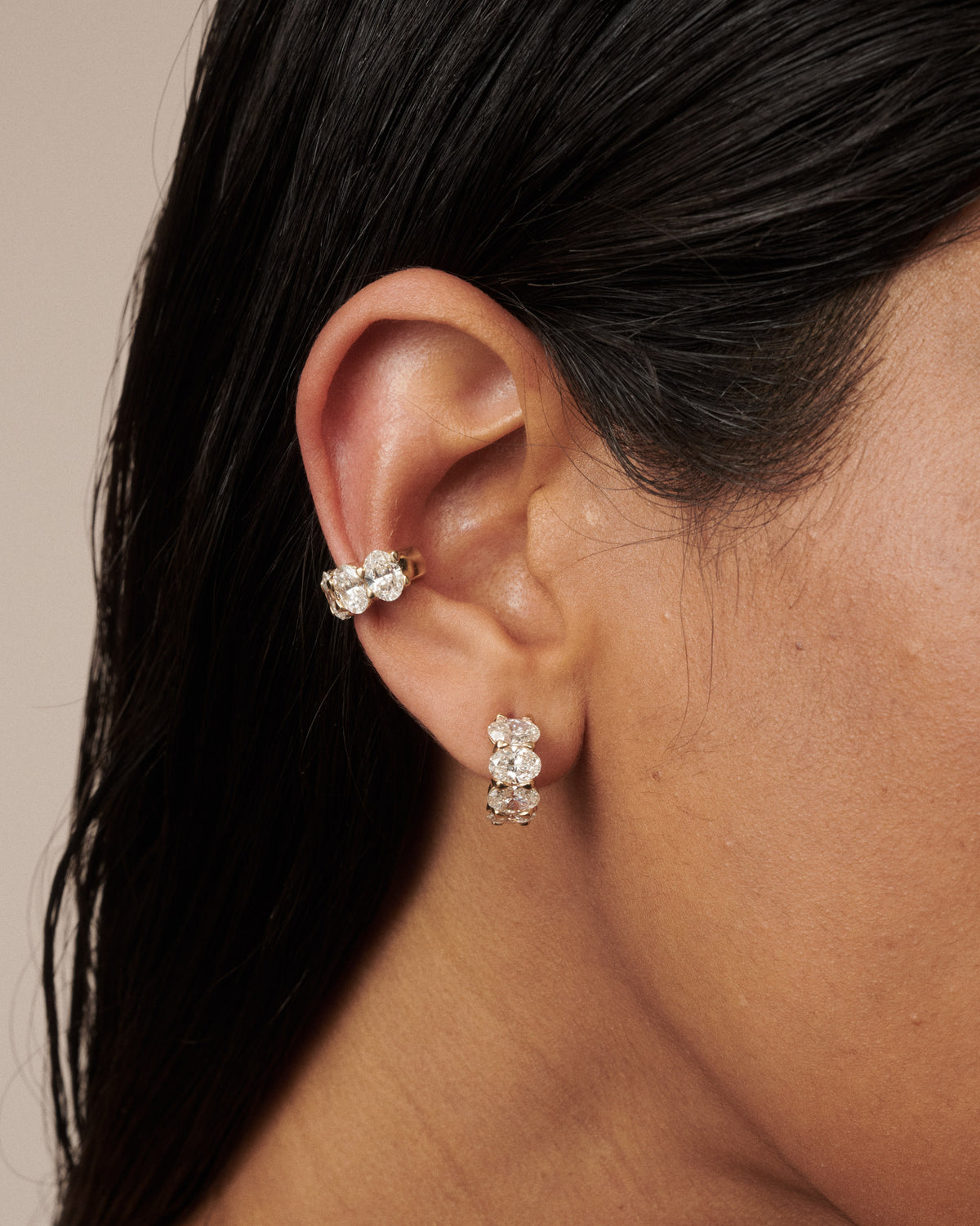 Gold oval lab-grown diamond cuff earring with clustered stones, worn on ear [text overlay: Camille Cuff paired with the Camille Hoops]