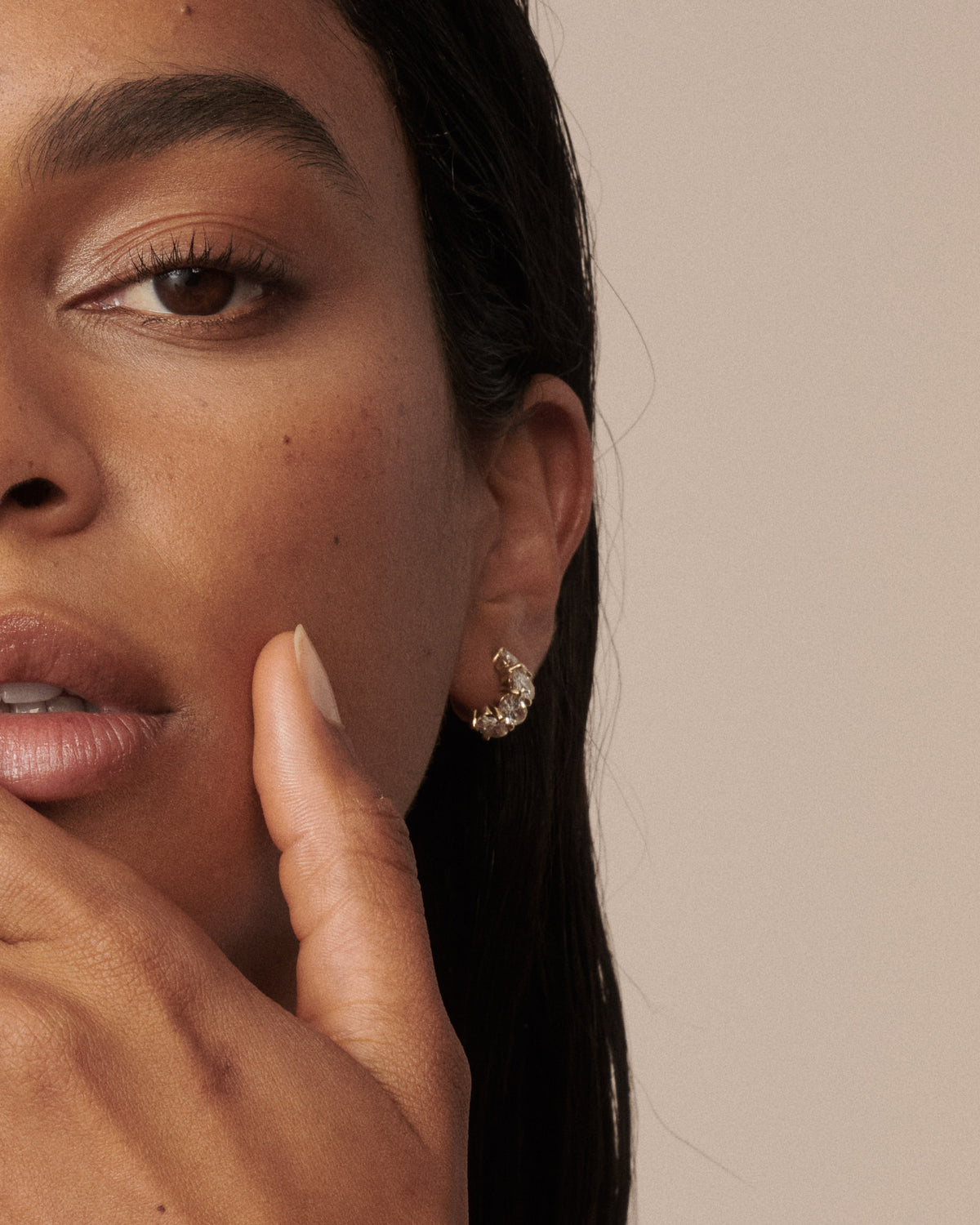 Oval lab-grown diamond hoop earrings in gold, angled close-up
