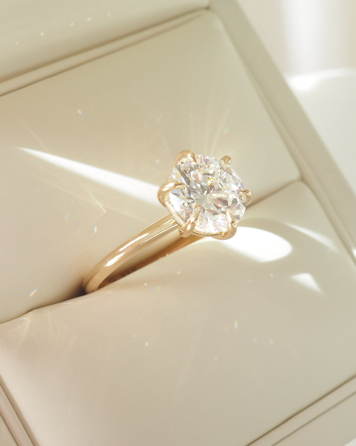 Round solitaire engagement ring in yellow gold with large central diamond
