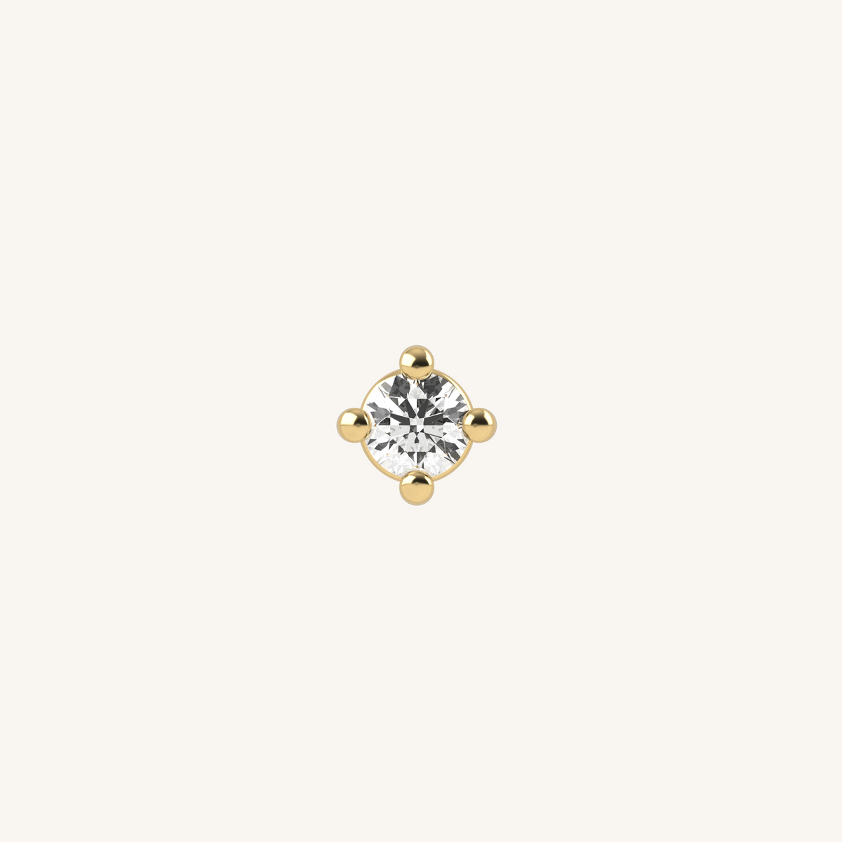 Tiny gold-tone fixed charm with round clear stone and four gold ball details