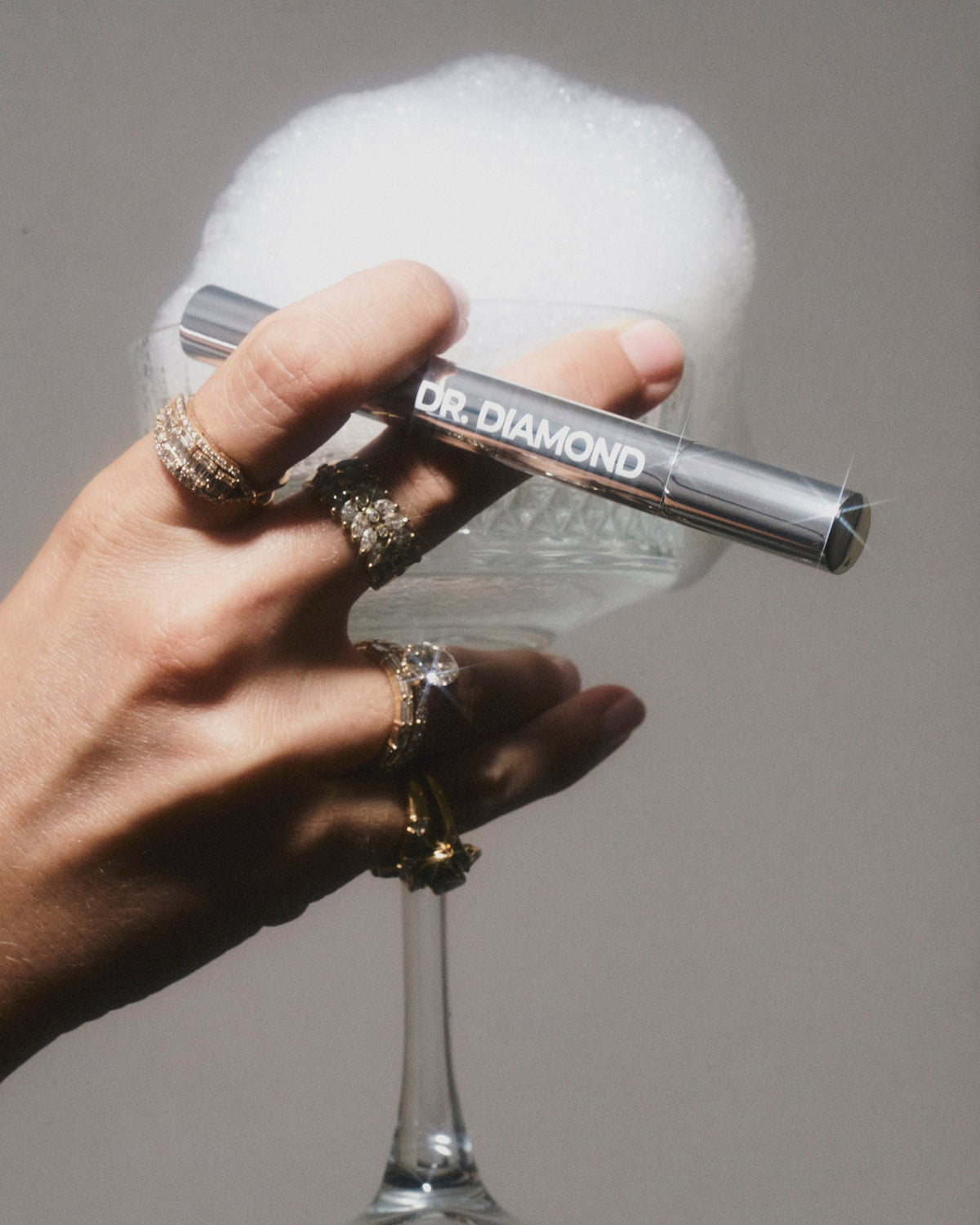 Dr. Diamond cleaning pen applying foam to diamond jewelry