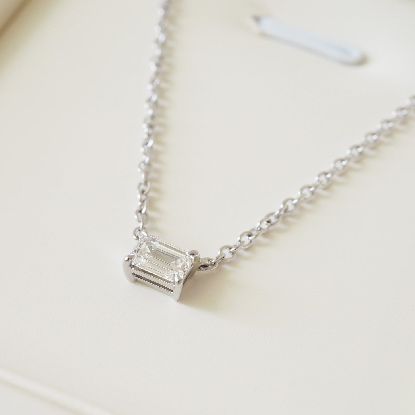 East-west emerald diamond necklace on white gold cable chain