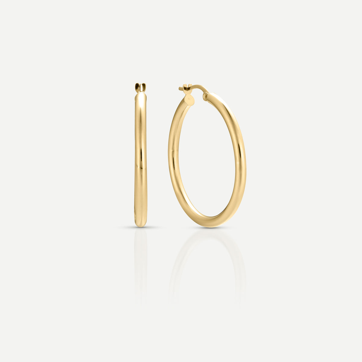 Elegant gold hoop earrings on a plain white background, showcasing their sleek and polished design.