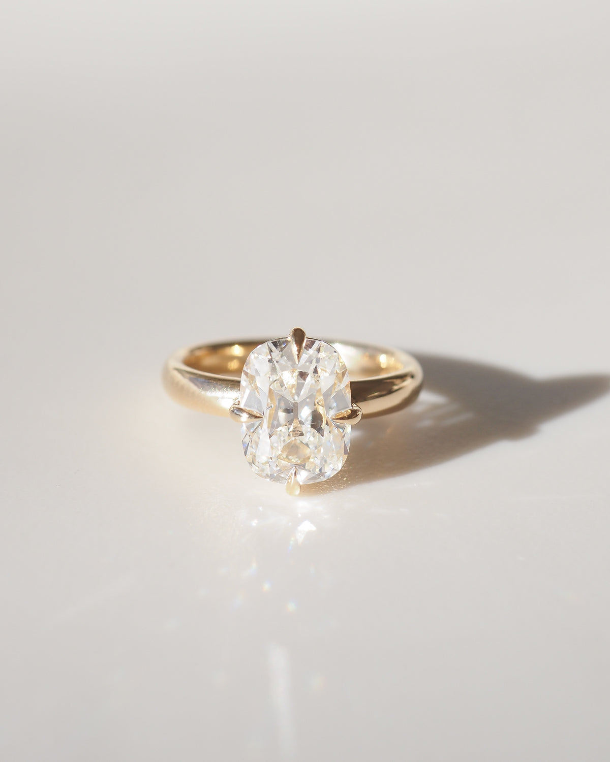Yellow gold cushion-cut lab-grown diamond solitaire ring, centered top view