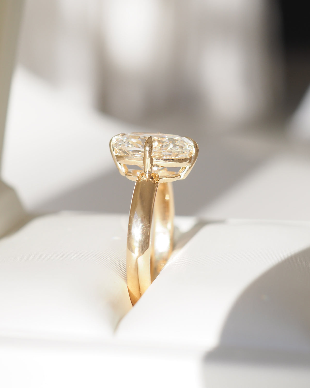 Yellow gold cushion-cut lab-grown diamond solitaire ring, slim band side view