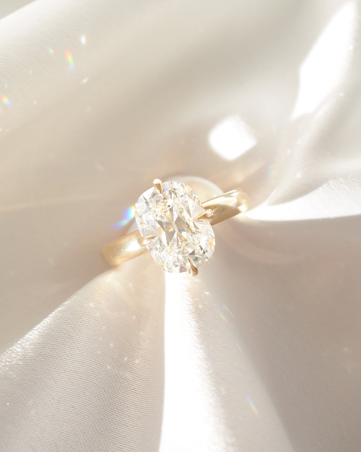 Yellow gold cushion-cut lab-grown diamond solitaire ring, prong-set round center