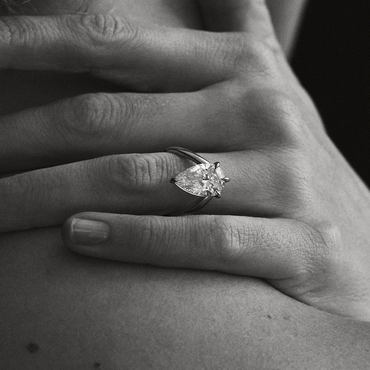 Gold ring with pear-cut solitaire diamond, open gallery setting