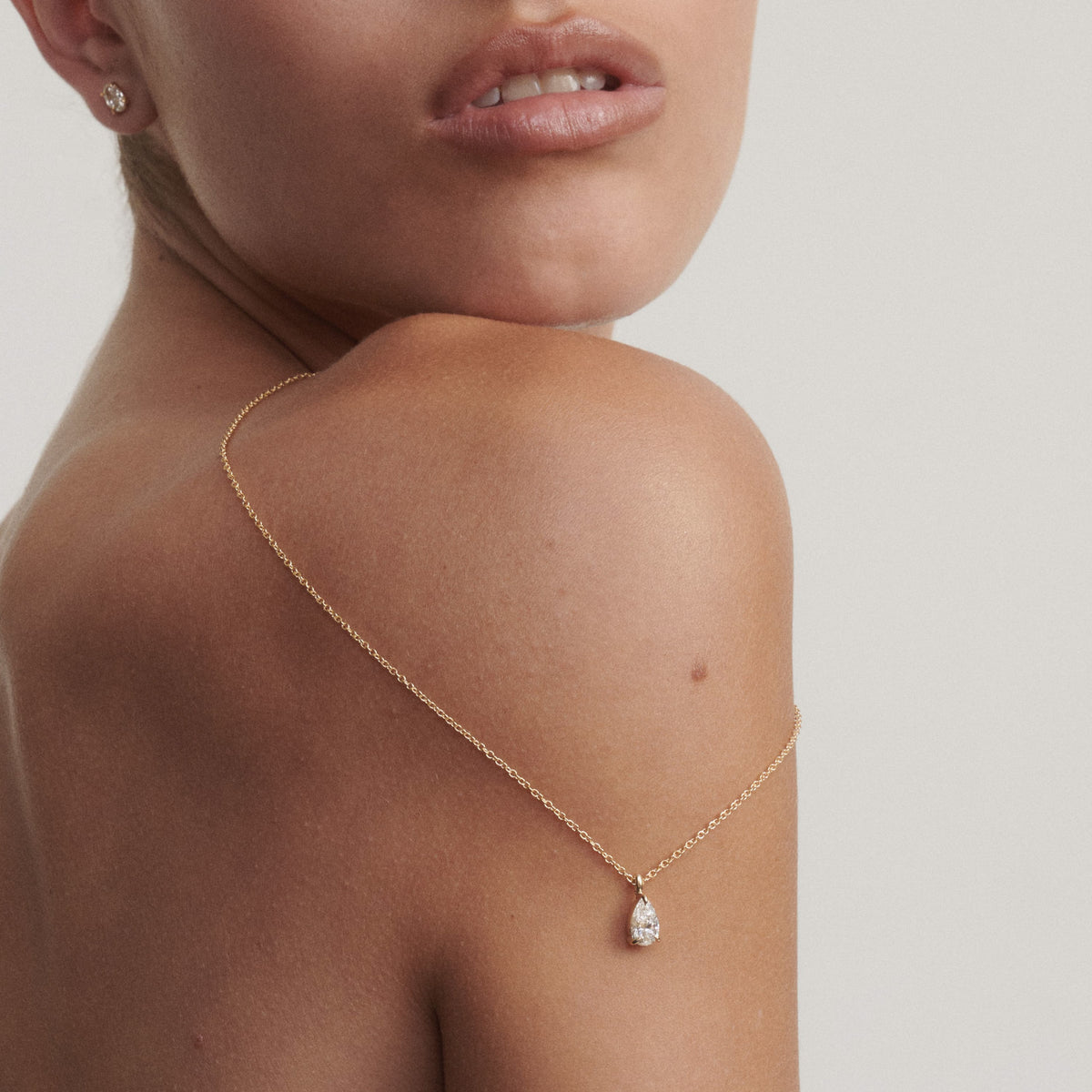 Pear-shaped diamond pendant necklace with yellow gold chain and teardrop drop detail
