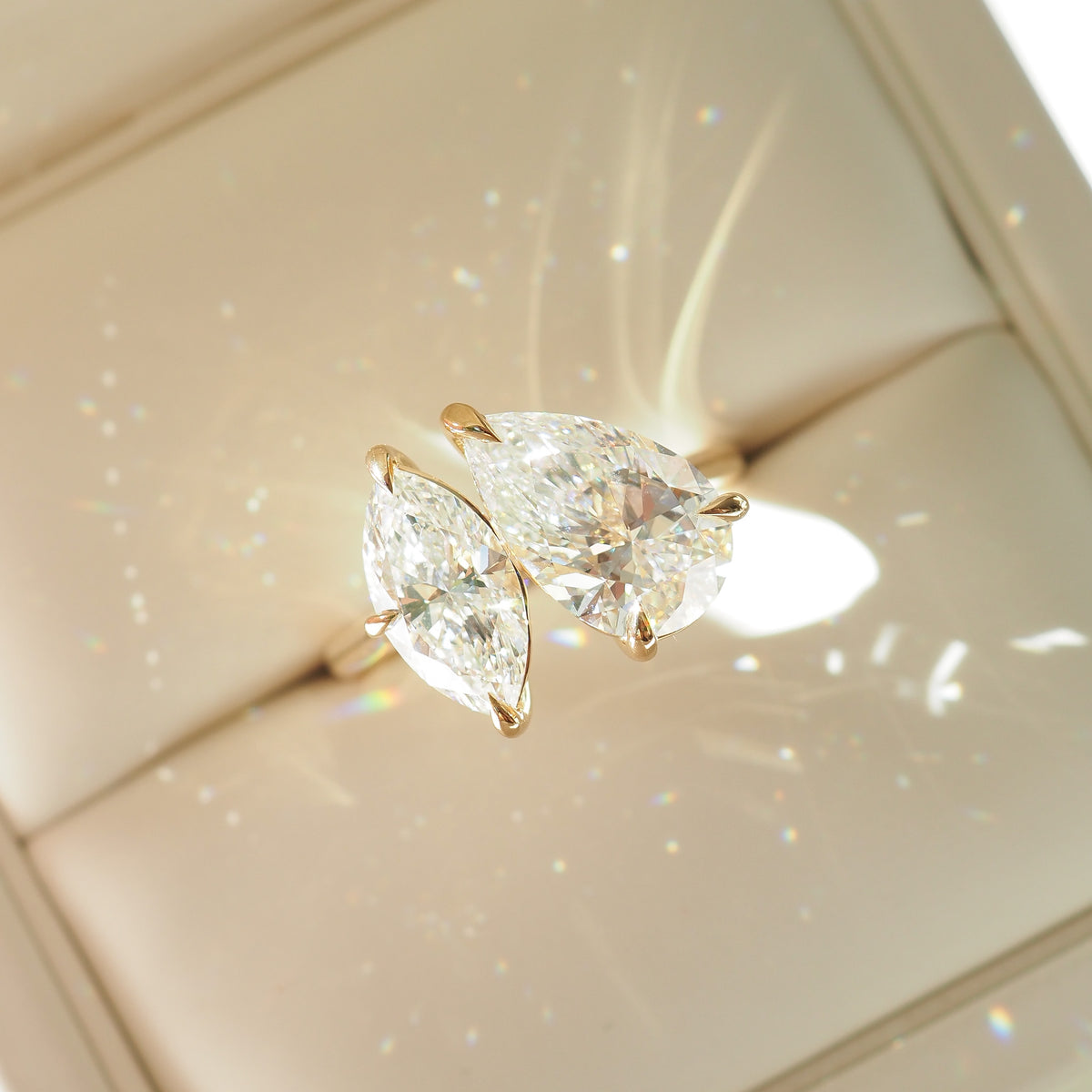Gold-tone toi et moi diamond ring with pear and marquise stones, slender band