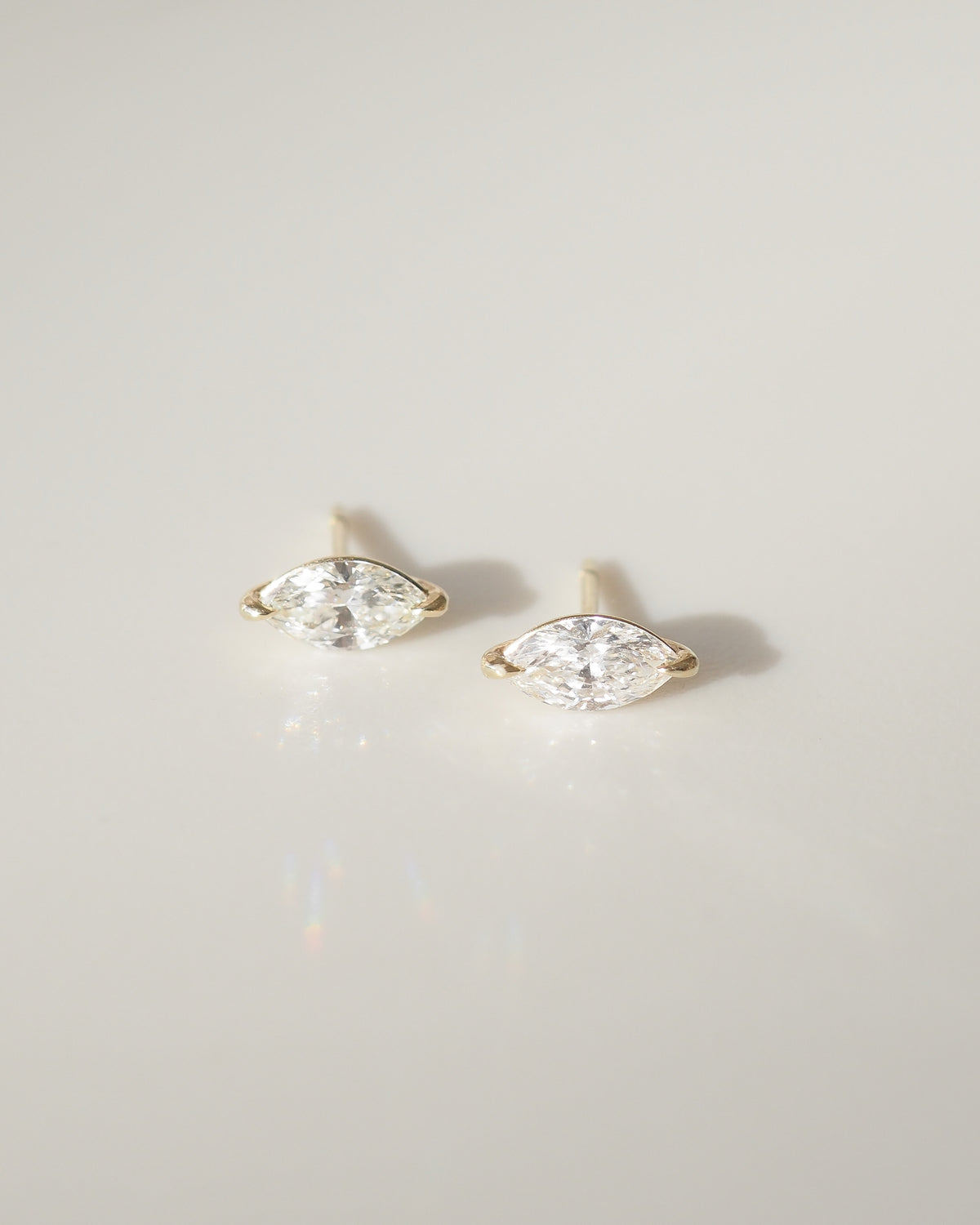 Pair of marquise diamond stud earrings with gold settings