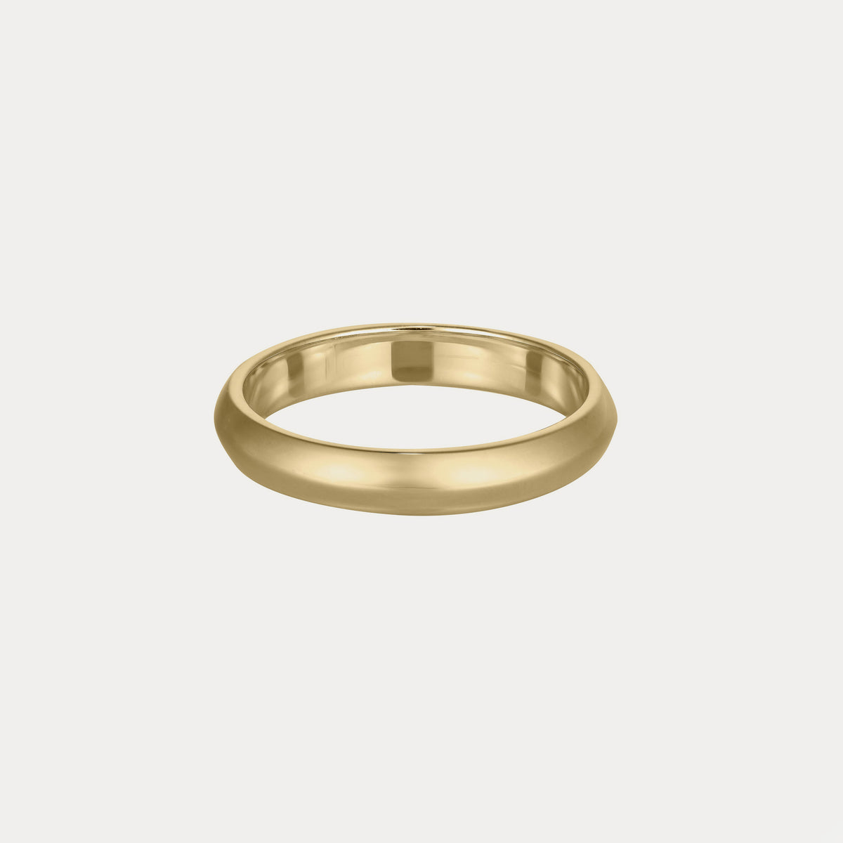 Sleek gold band ring on a plain background, showcasing its smooth, luxurious finish. Simple yet elegant design.