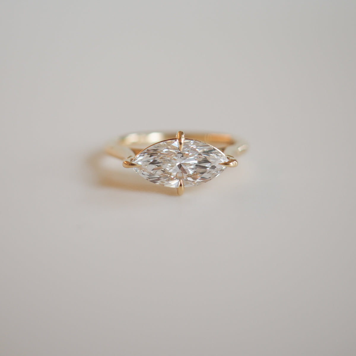 Gold ring featuring a marquise-cut diamond, elegantly set on a minimalist band, showcasing luxury jewellery design.