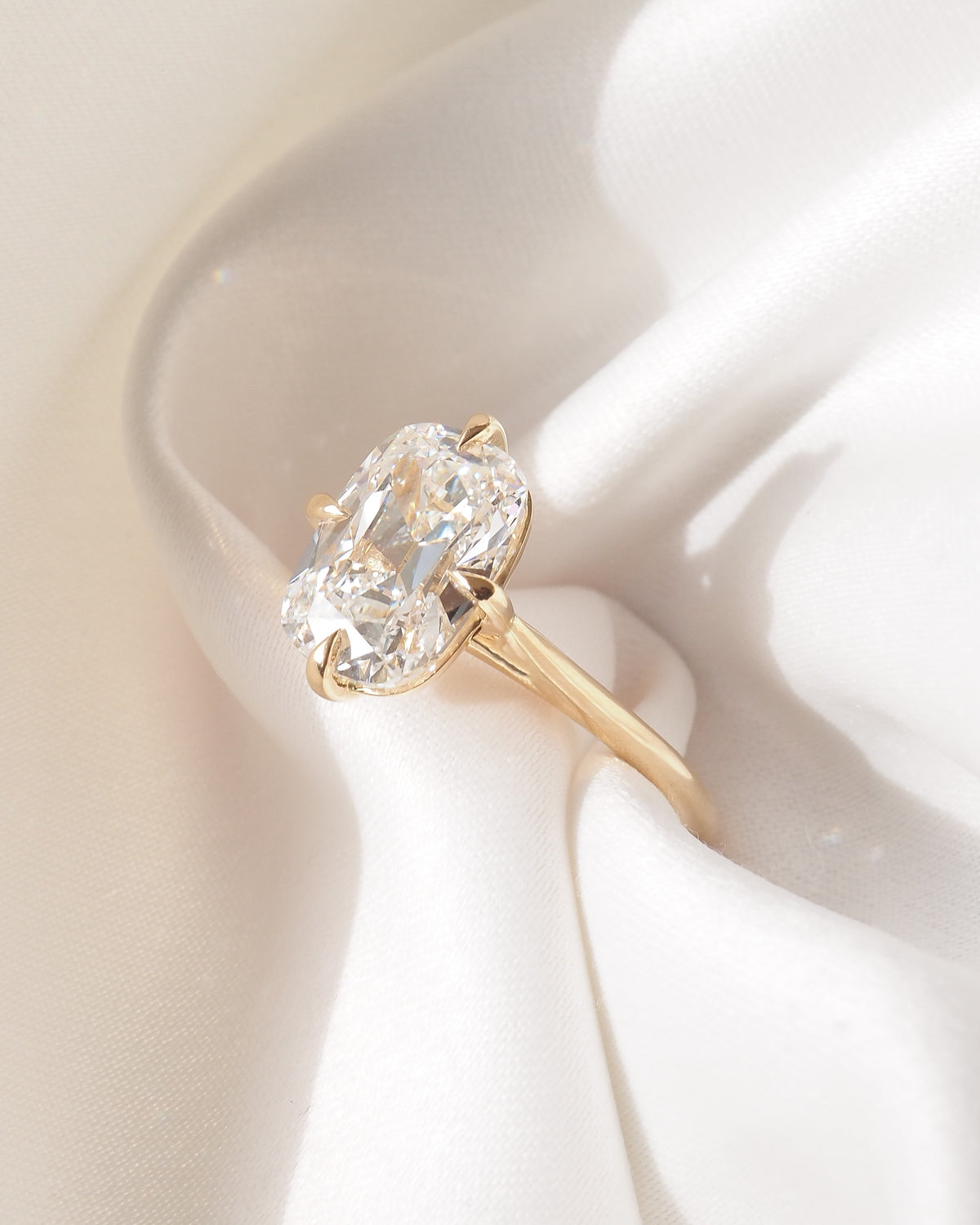 Gold ring with cushion-cut lab-grown diamond, close-up of halo and prongs