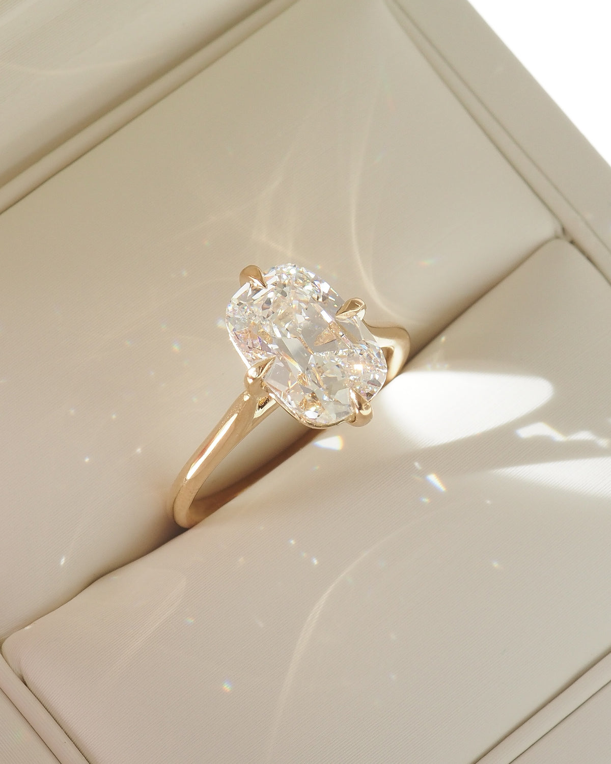 Gold ring with cushion-cut lab-grown diamond and clustered halo setting