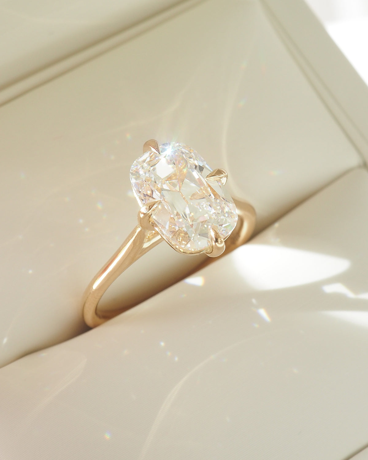 Gold ring with cushion-cut lab-grown diamond and scalloped halo setting