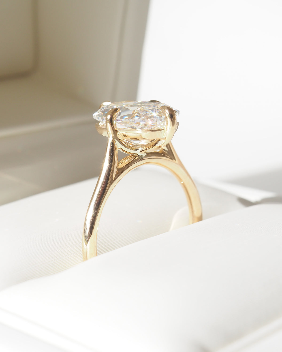 Cushion-cut lab-grown diamond ring with thin gold band and side profile