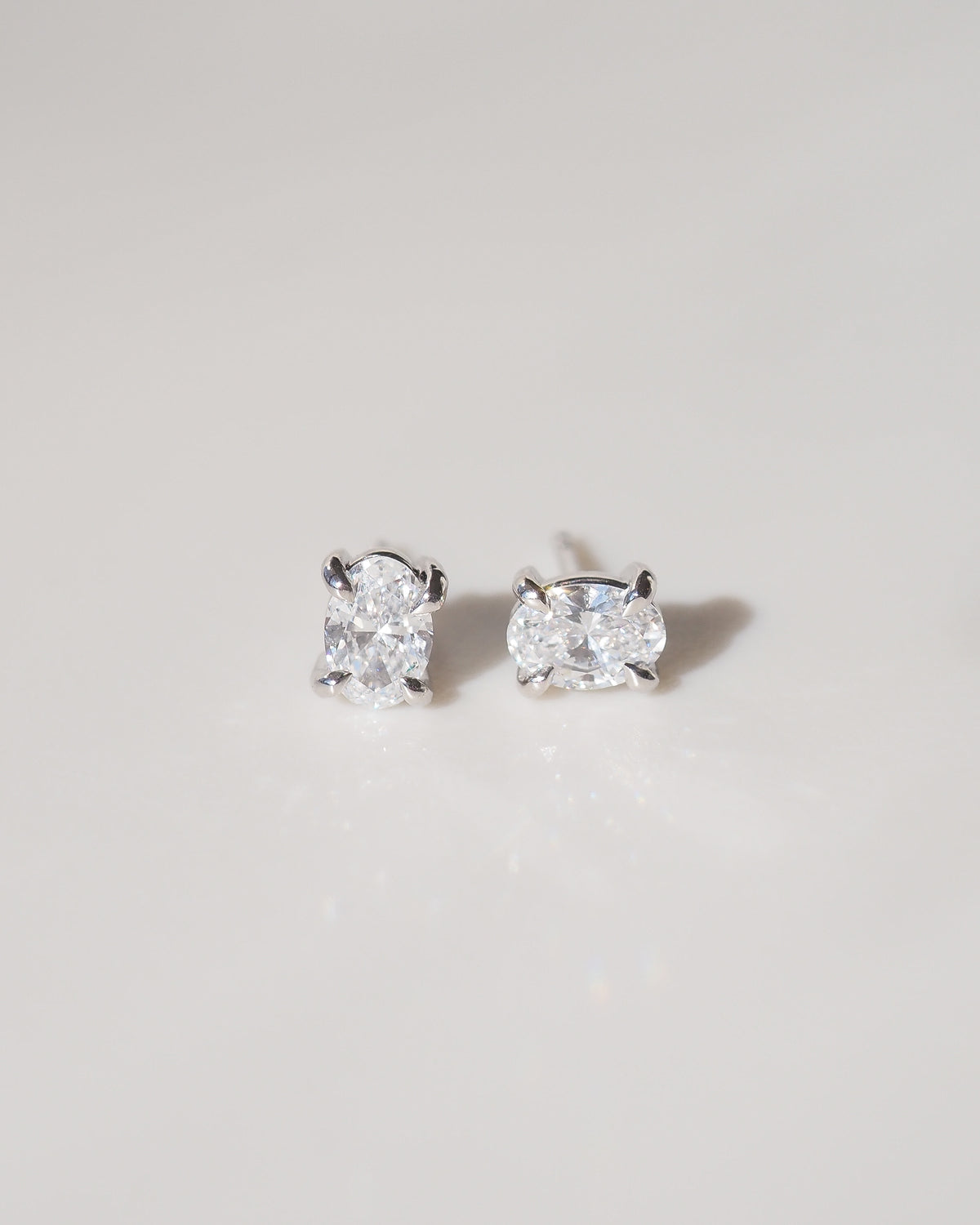 Pair of oval-cut 9ct white gold stud earrings with clear stone centers