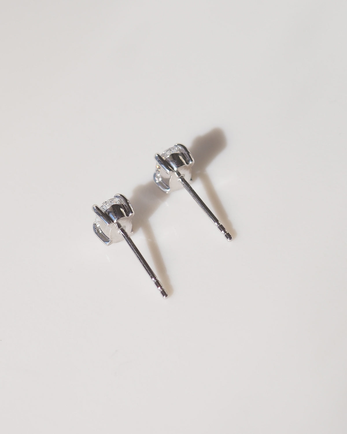 Back view of oval 9ct white gold stud earrings with hinge-style backs and posts