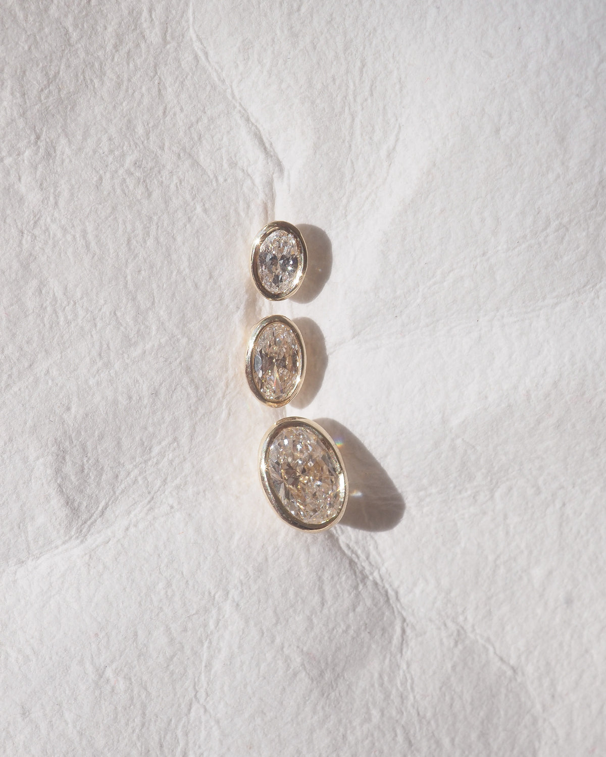Oval bezel lab-grown diamond stud earrings, two oval bezels with sparkle
