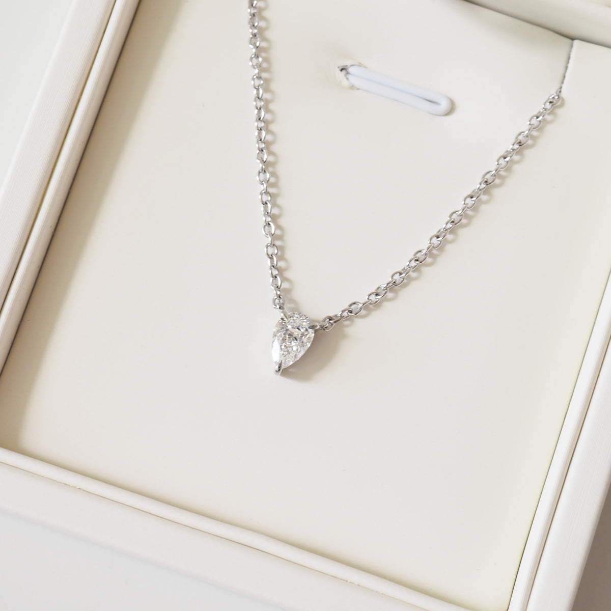 Pear-shaped diamond pendant necklace on silver link chain