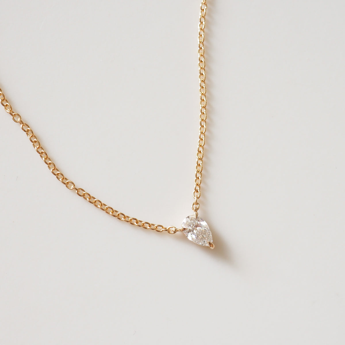Gold pear-cut diamond necklace with fixed pendant on fine chain