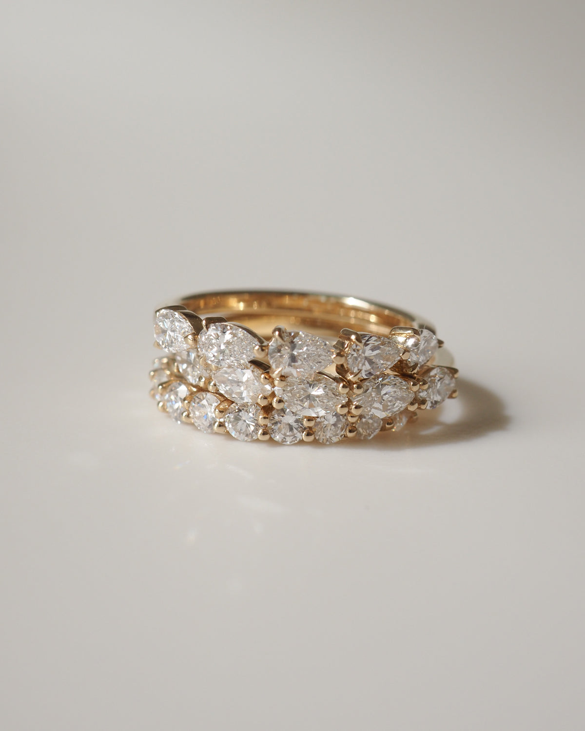 Gold ring adorned with sparkling diamonds, capturing an elegant and luxurious jewellery design on a soft-focus background.