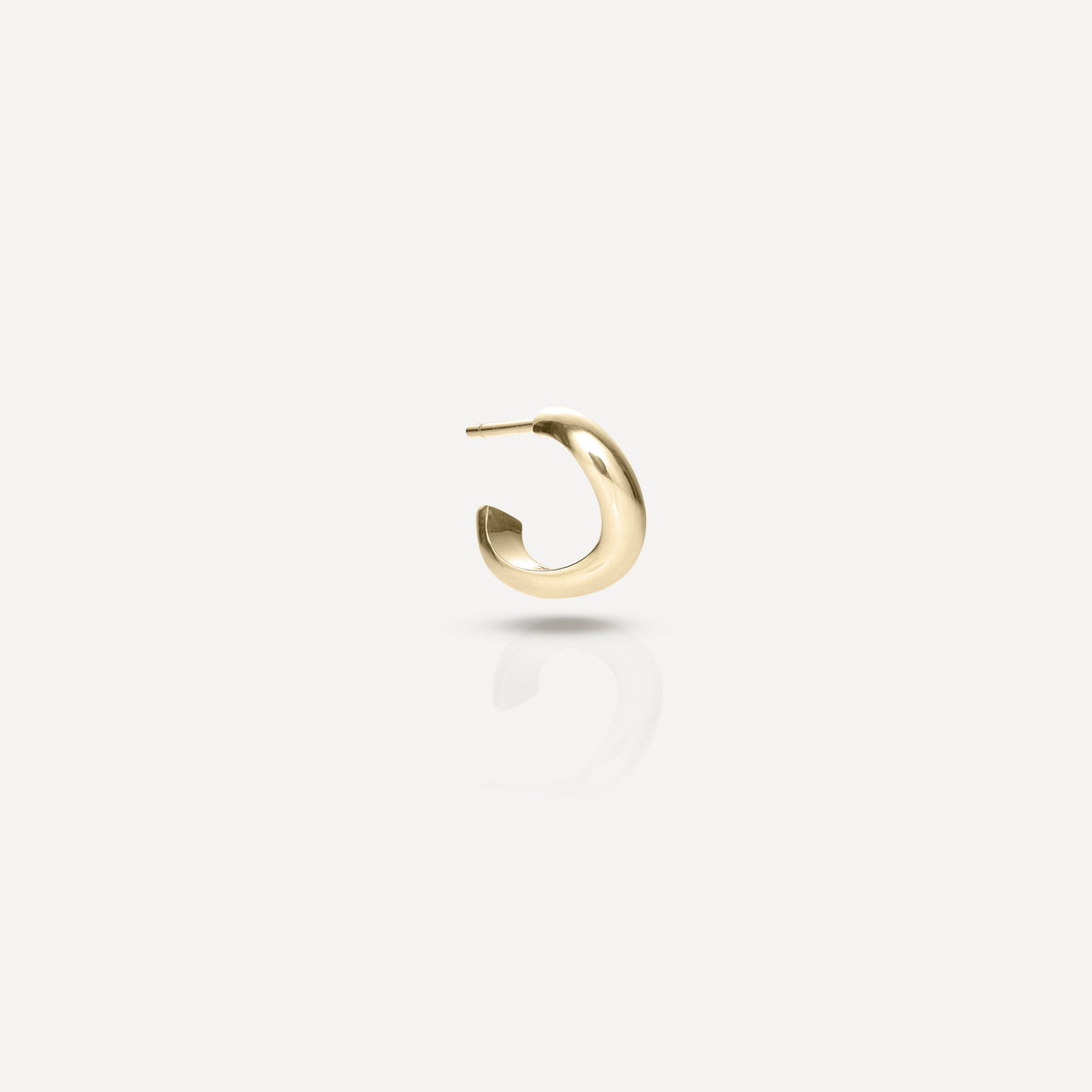 Gold hoop earring with a sleek, polished finish displayed on a light grey background. Luxury jewellery accessory.